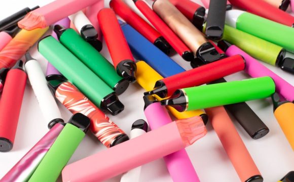 Set of colorful disposable electronic cigarettes of different shapes on a white background. The concept of modern smoking